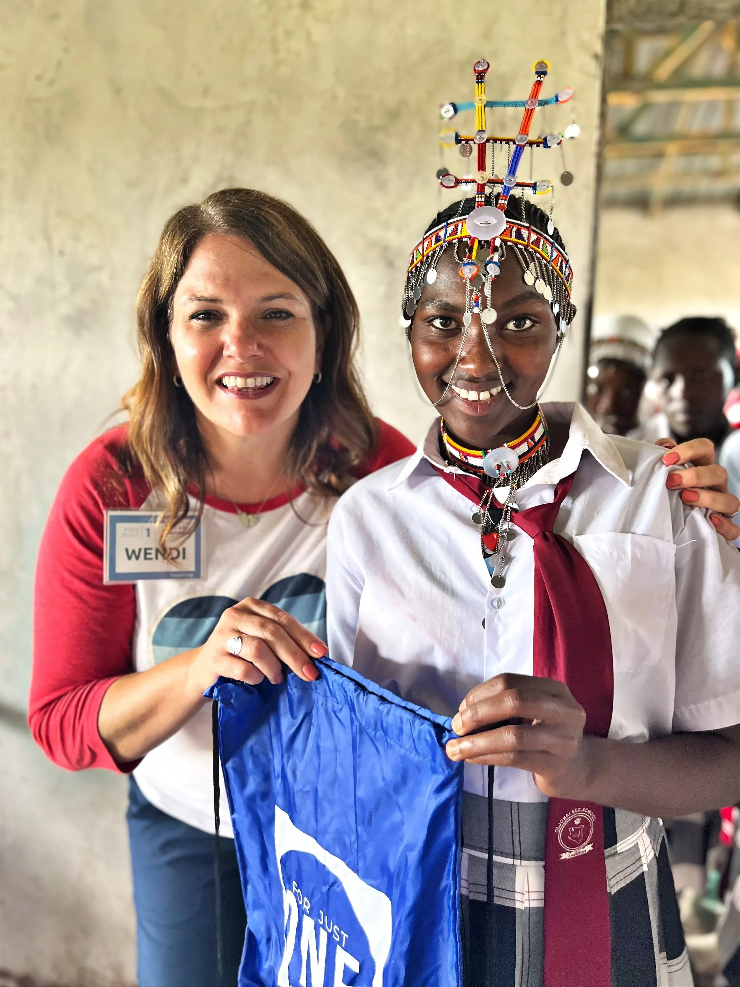 Wendi Lester Efflandt, Founder of For Just 1, with a young Maasai girl in rural Kenya